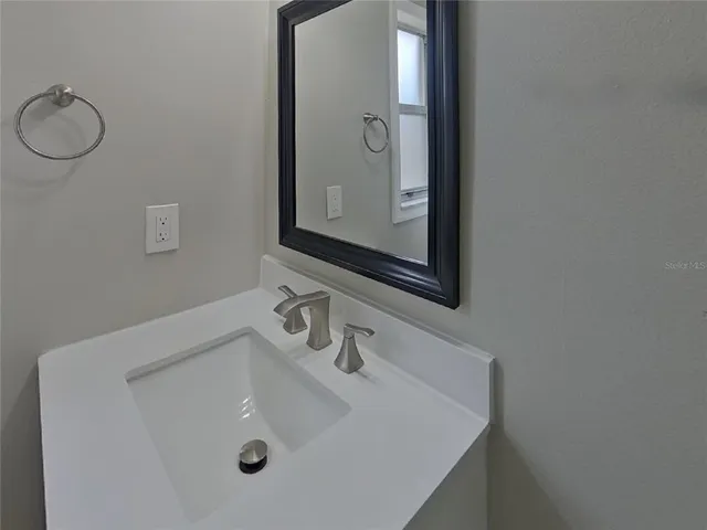a bathroom with a sink and mirror