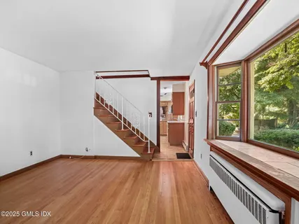 a view of an entryway with wooden floor
