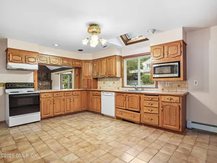 a kitchen with granite countertop a stove cabinets and a sink