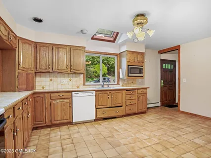 a kitchen with stainless steel appliances granite countertop a stove a sink dishwasher and a refrigerator