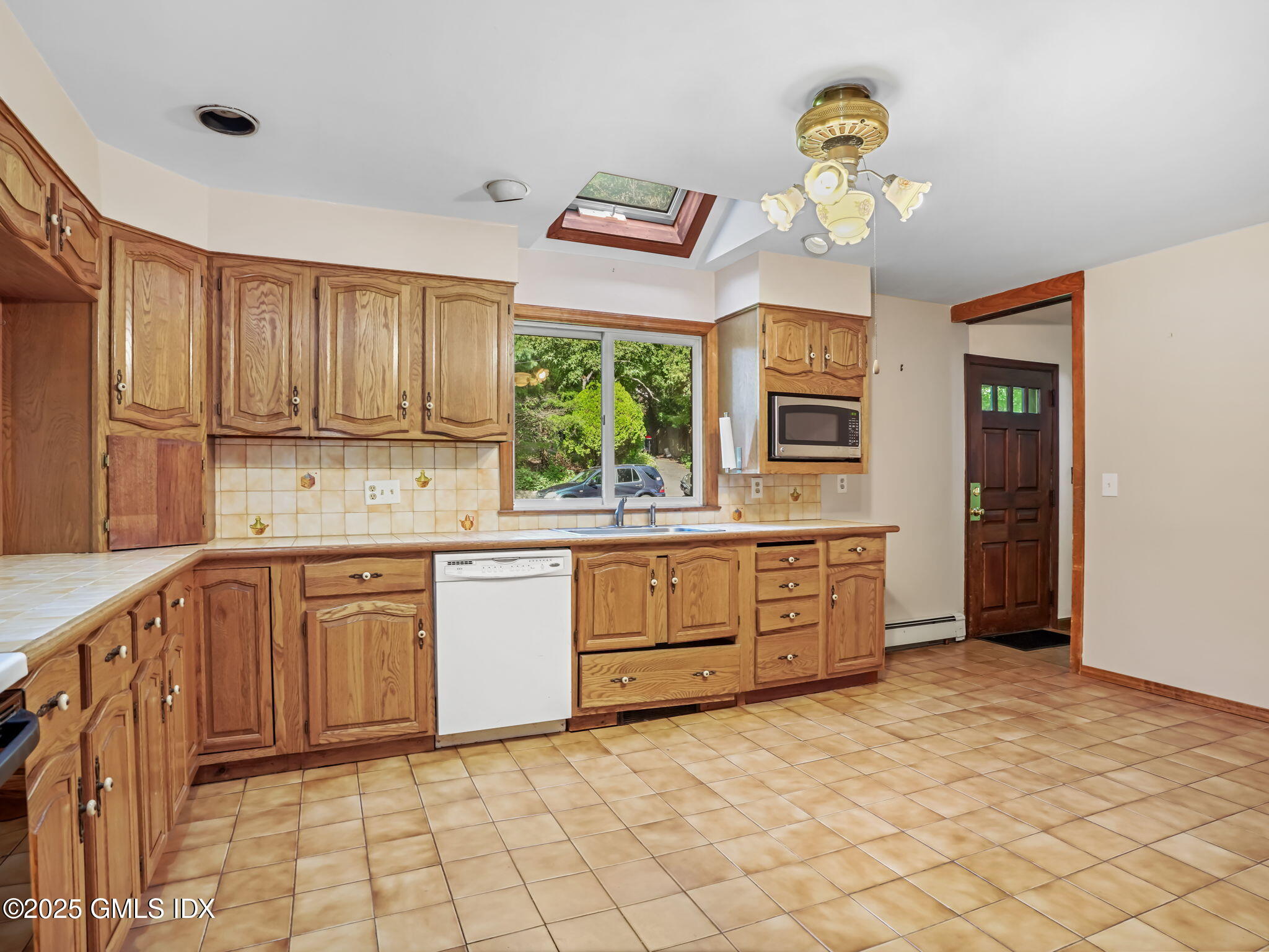 11 Perna Lane Riverside, CT 06878 - Photo 5 of 12 a kitchen with stainless steel appliances granite countertop a stove a sink dishwasher and a refrigerator