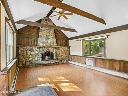 a view of an empty room with a fireplace and a window