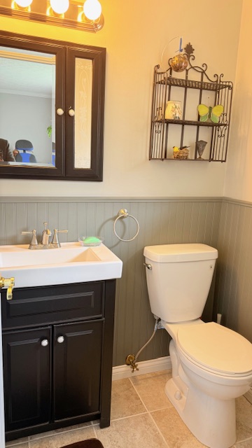 3361 Turner Drive Springfield, OH 45504 - Photo 15 of 18 This bathroom features wainscoting and a vanity with a sleek sink and storage.