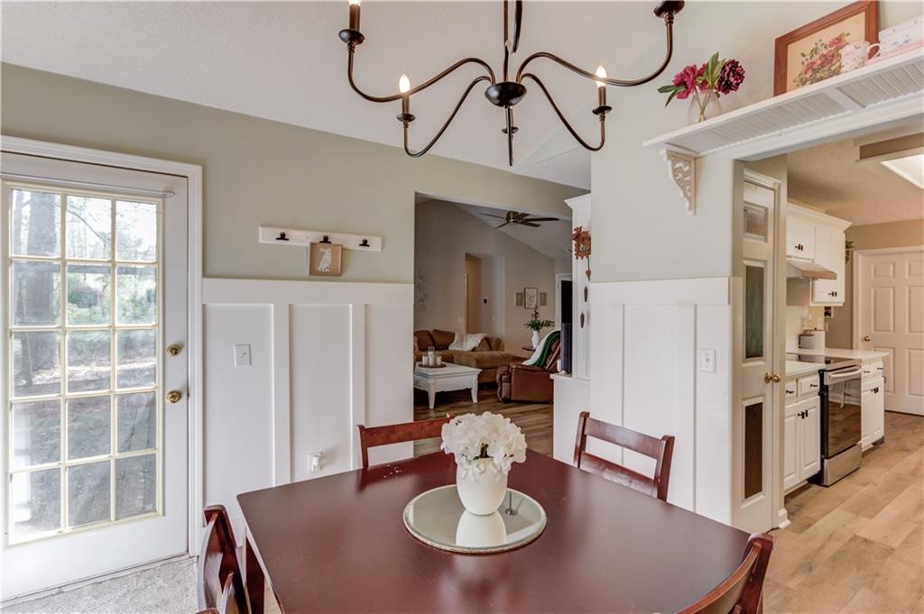 925 Nature Trail Bethlehem, GA 30620 - Photo 14 of 41 a view of a dining room with furniture a chandelier and wooden floor