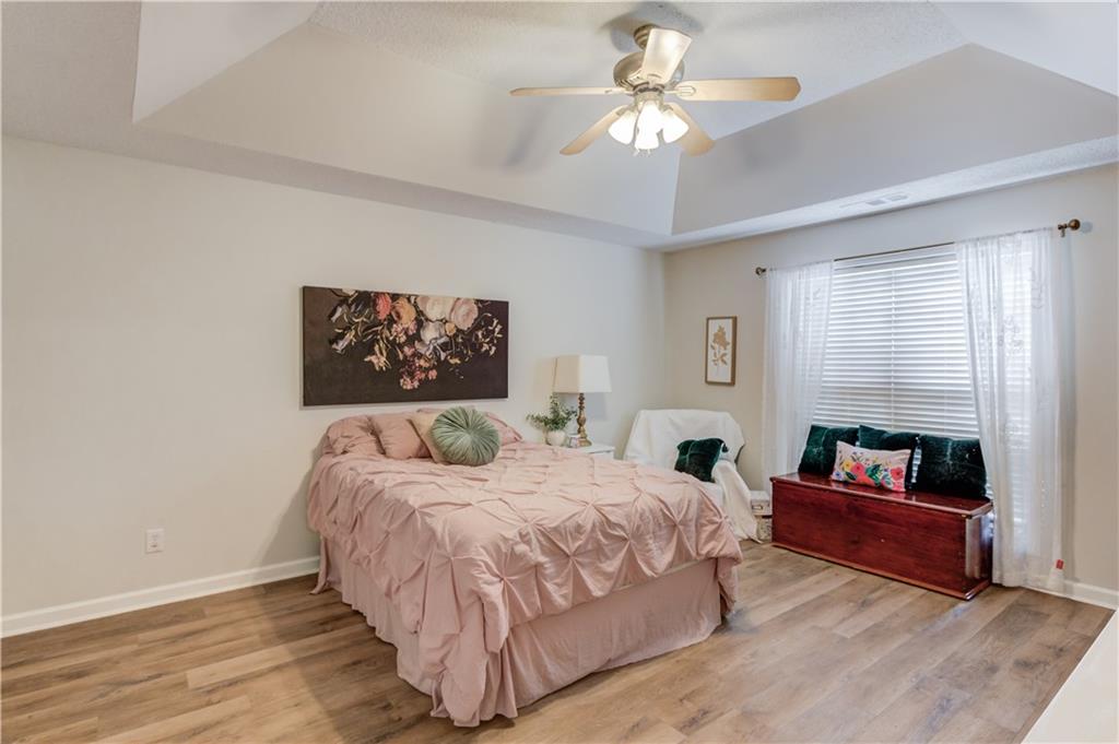 925 Nature Trail Bethlehem, GA 30620 - Photo 19 of 41 a bedroom with a large bed and a chandelier