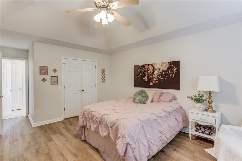 925 Nature Trail Bethlehem, GA 30620 - Photo 20 of 41 a bedroom with a large bed and a chandelier