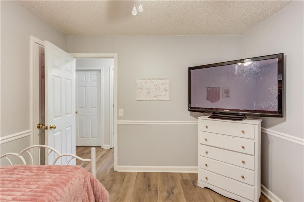 925 Nature Trail Bethlehem, GA 30620 - Photo 25 of 41 a bedroom with a bed and a flat tv screen on the dresser
