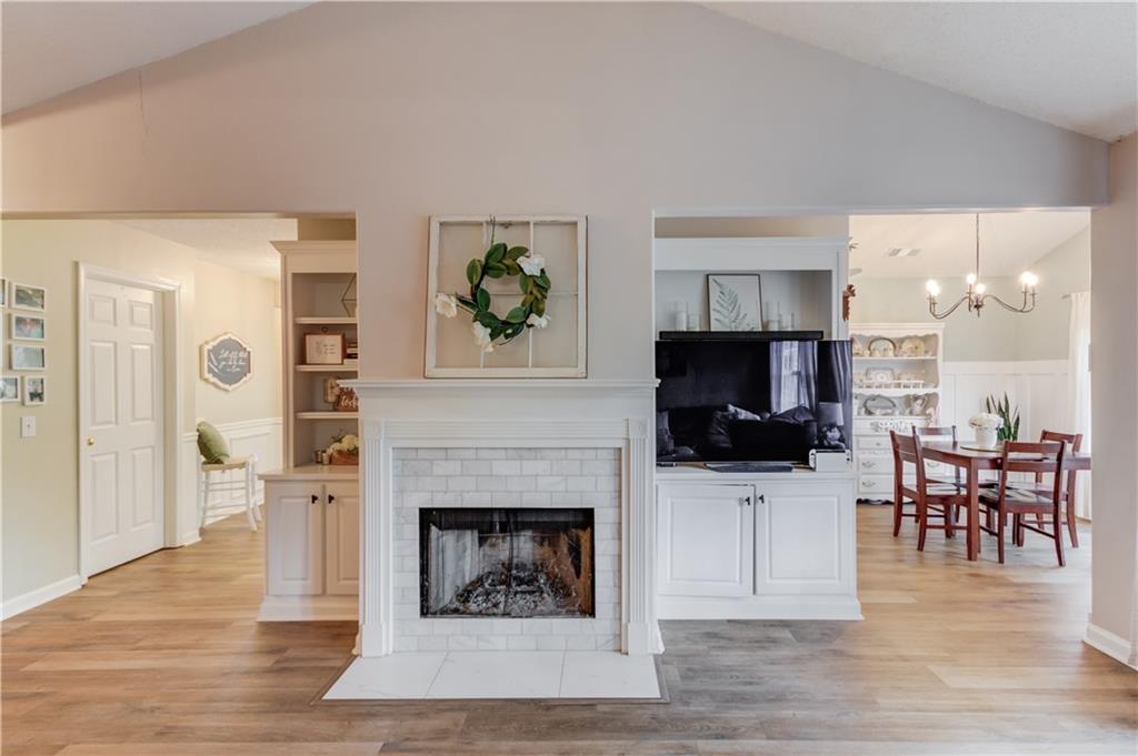 925 Nature Trail Bethlehem, GA 30620 - Photo 9 of 41 a living room with furniture a flat screen tv and a fireplace