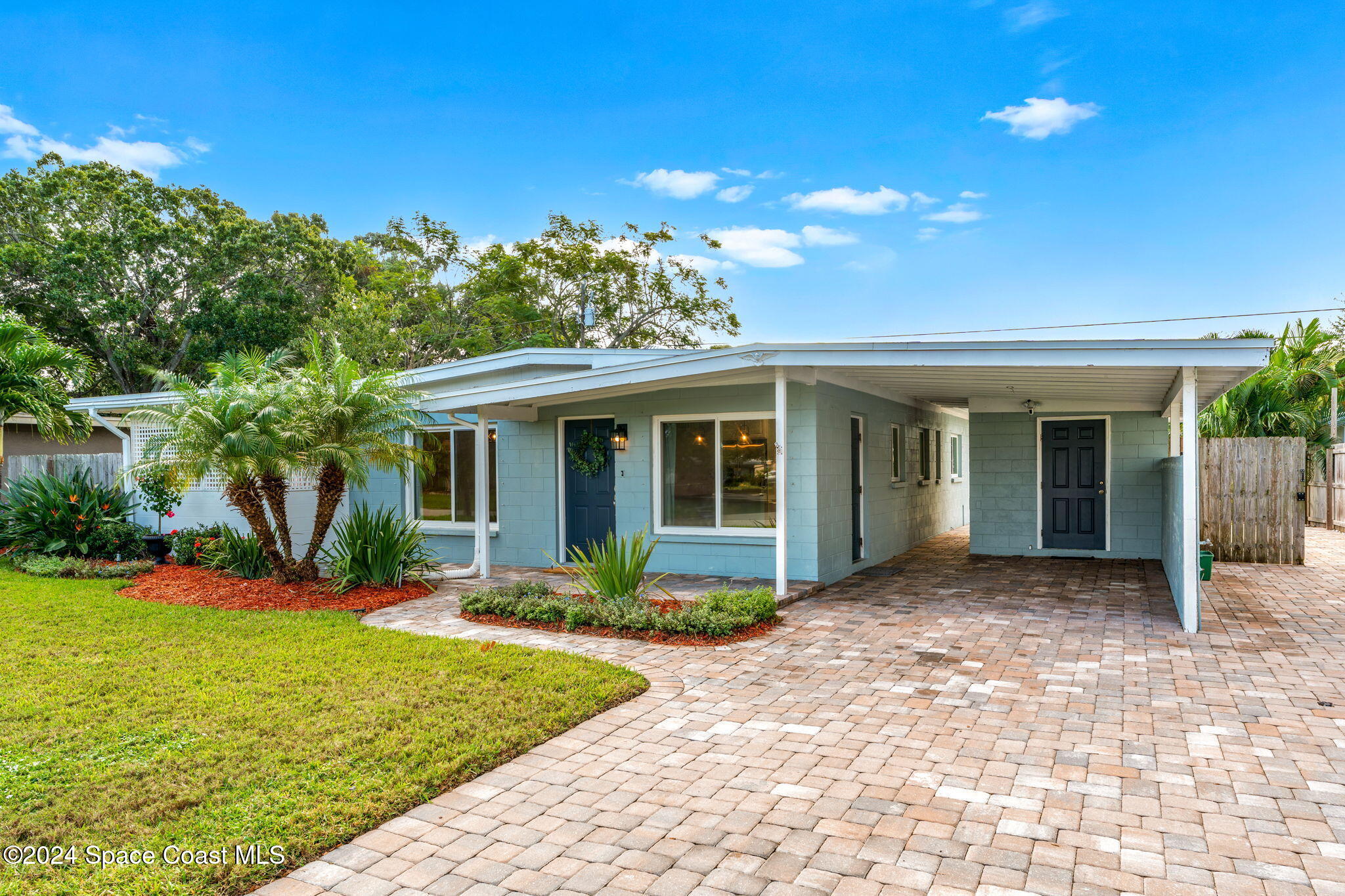 5120 Sutton Avenue Melbourne, FL 32904 - Photo 1 of 38 a front view of a house with garden
