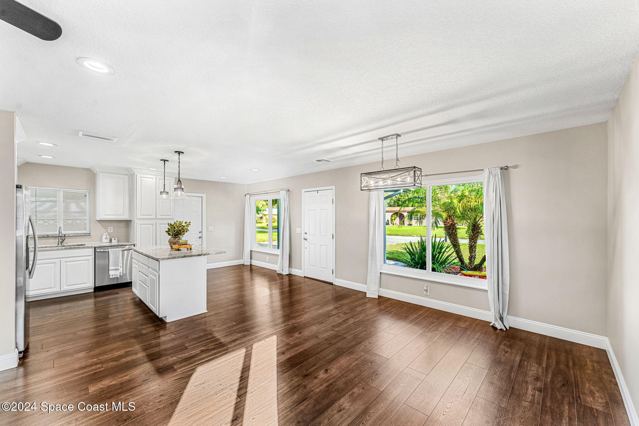 5120 Sutton Avenue Melbourne, FL 32904 - Photo 13 of 38 a kitchen with a wooden floor and window