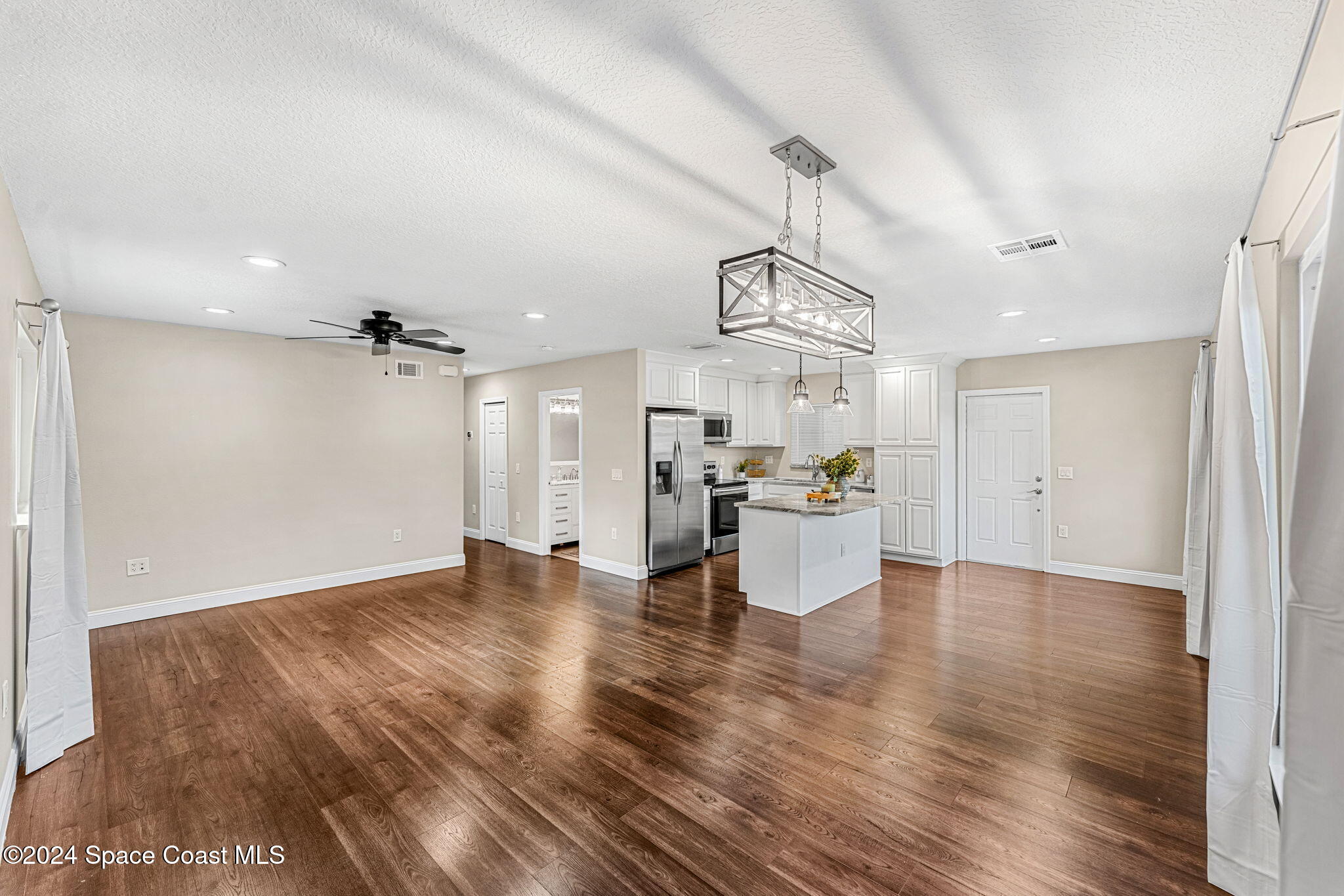 5120 Sutton Avenue Melbourne, FL 32904 - Photo 14 of 38 a view of empty room with wooden floor