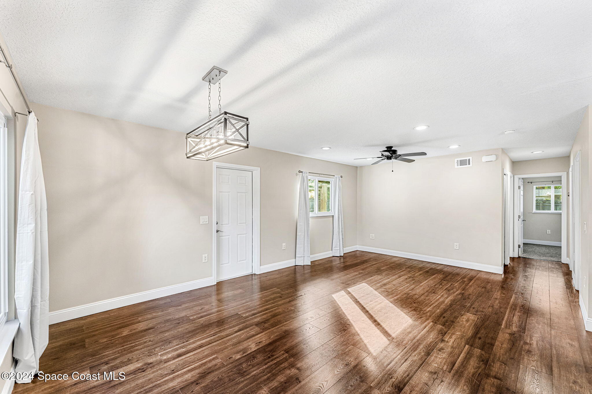 5120 Sutton Avenue Melbourne, FL 32904 - Photo 15 of 38 a view of empty room with wooden floor