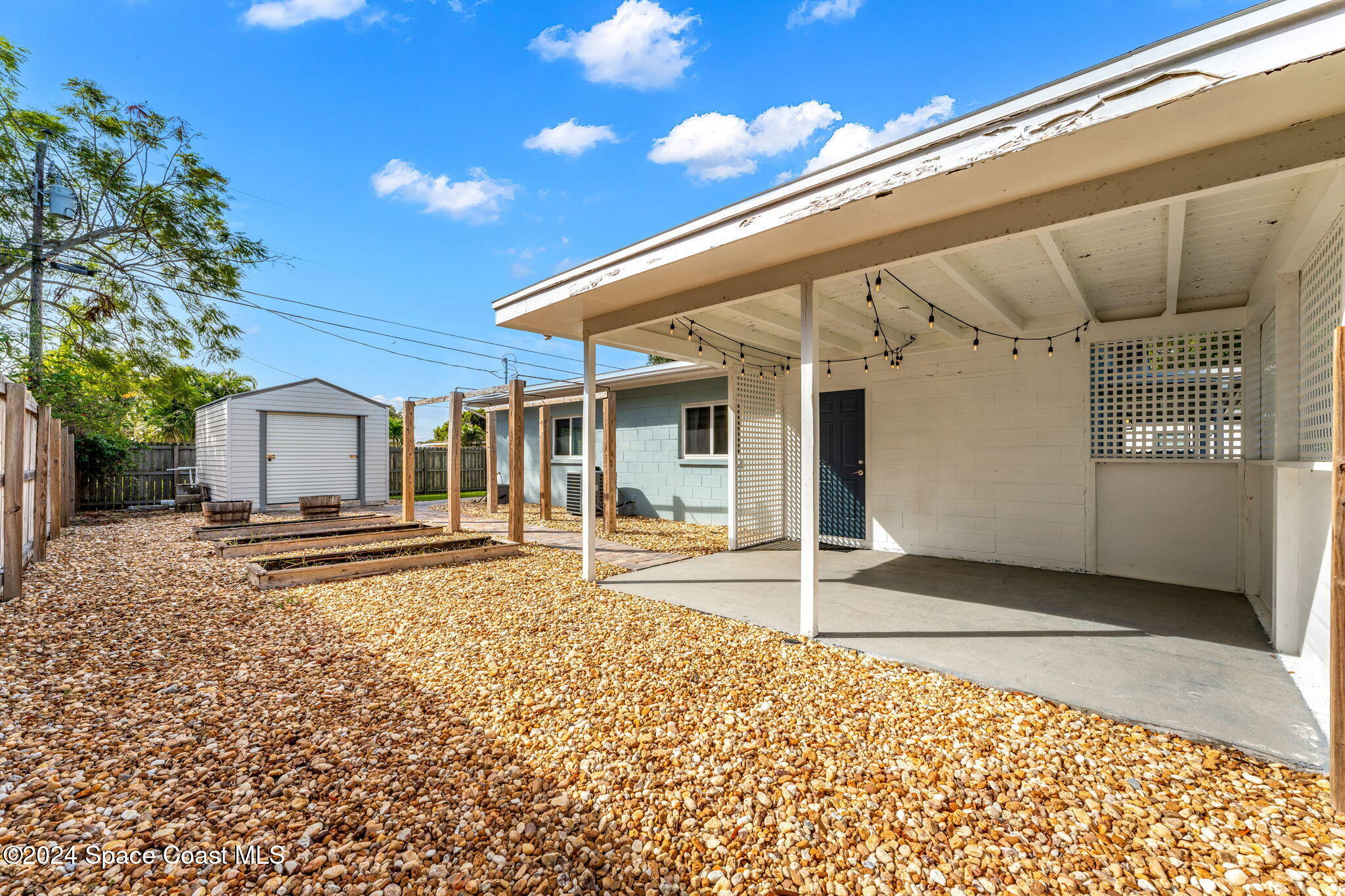5120 Sutton Avenue Melbourne, FL 32904 - Photo 29 of 38 a view of a house with a patio and a yard