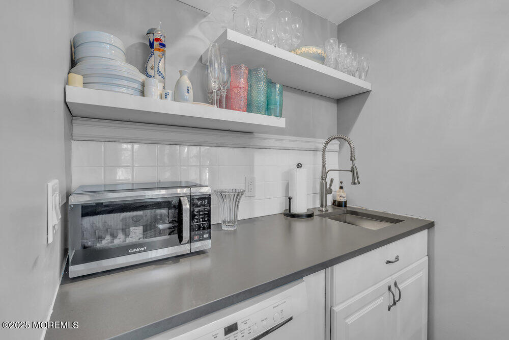 19 Gravelly Point Road Highlands, NJ 07732 - Photo 11 of 44 a kitchen with a sink cabinets and stainless steel appliances