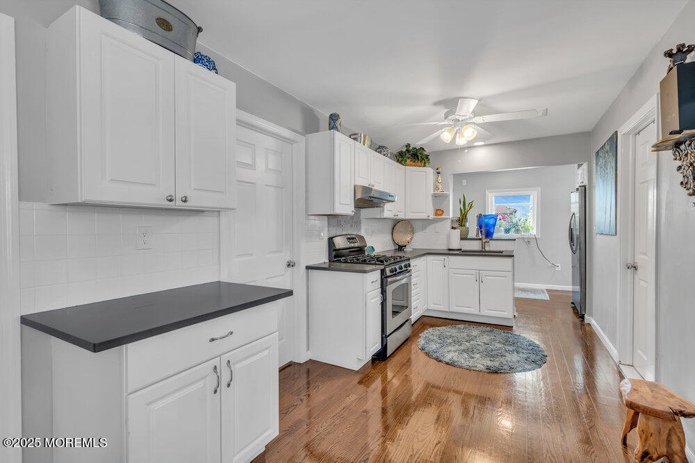 19 Gravelly Point Road Highlands, NJ 07732 - Photo 13 of 44 a kitchen with white cabinets and appliances