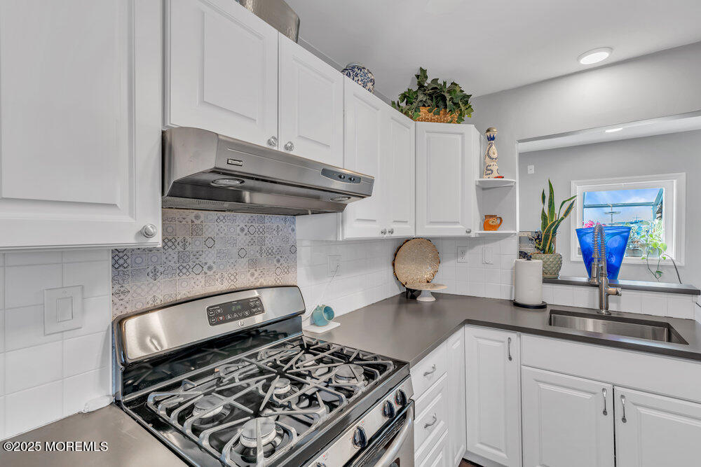 19 Gravelly Point Road Highlands, NJ 07732 - Photo 15 of 44 a kitchen with white cabinets and appliances