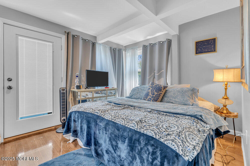 19 Gravelly Point Road Highlands, NJ 07732 - Photo 20 of 44 a bedroom with a bed and a flat screen tv