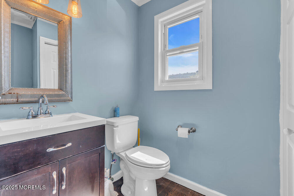 19 Gravelly Point Road Highlands, NJ 07732 - Photo 23 of 44 a bathroom with a toilet a sink and a mirror