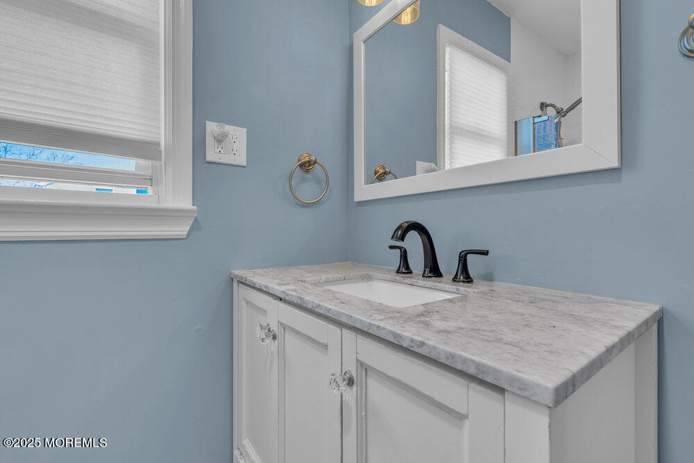 19 Gravelly Point Road Highlands, NJ 07732 - Photo 28 of 44 a bathroom with a sink and a mirror