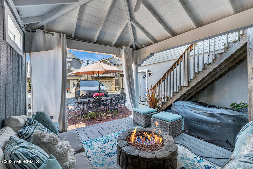 19 Gravelly Point Road Highlands, NJ 07732 - Photo 36 of 44 a living room with furniture and a chandelier
