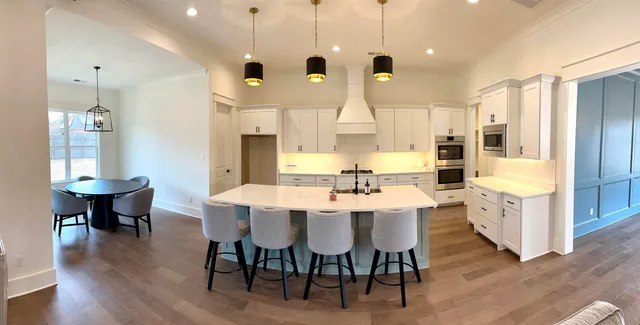 a large kitchen with a table and chairs
