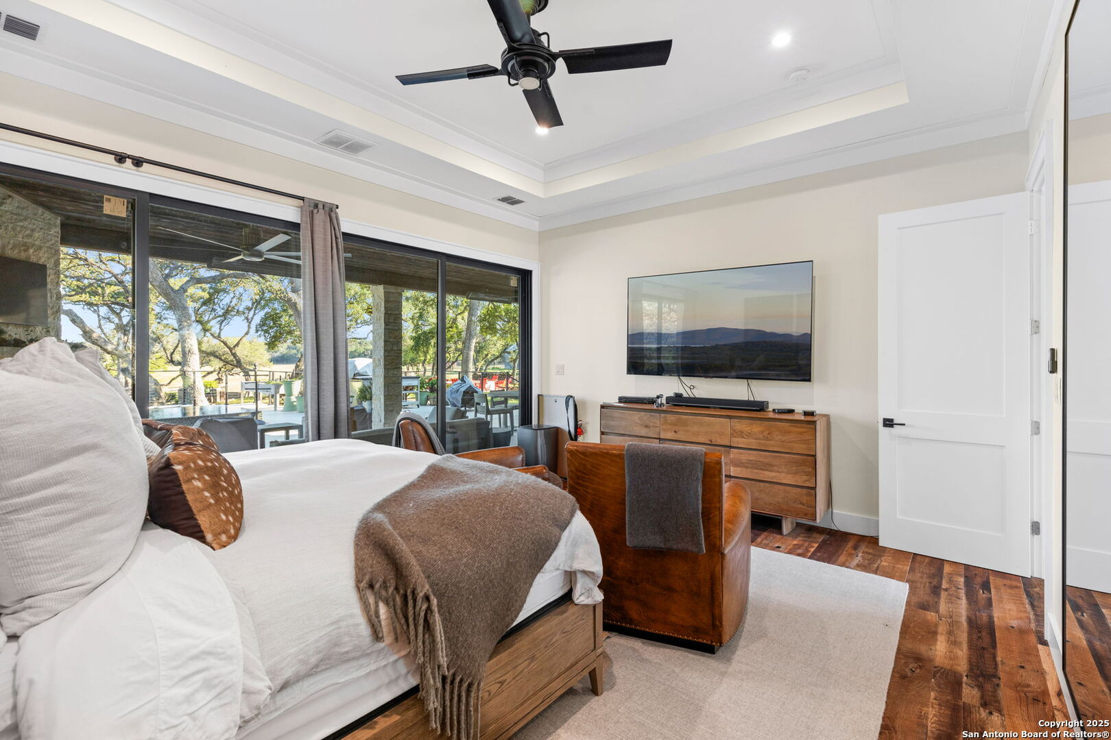 1146 Sisterdale Road Boerne, TX 78006 - Photo 14 of 94 a bedroom with a bed and a flat screen tv