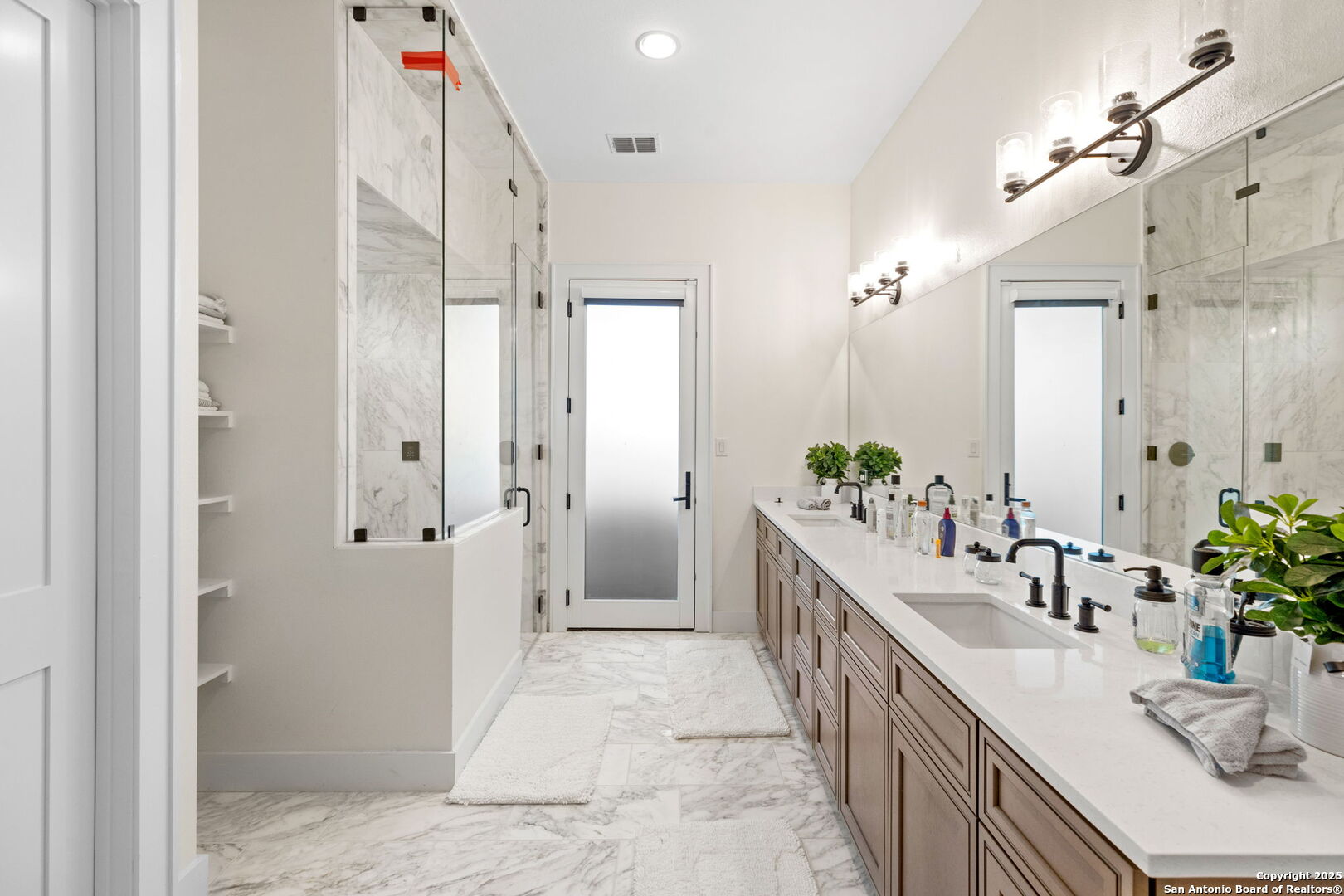 1146 Sisterdale Road Boerne, TX 78006 - Photo 15 of 94 a bathroom with a double vanity sink and a mirror