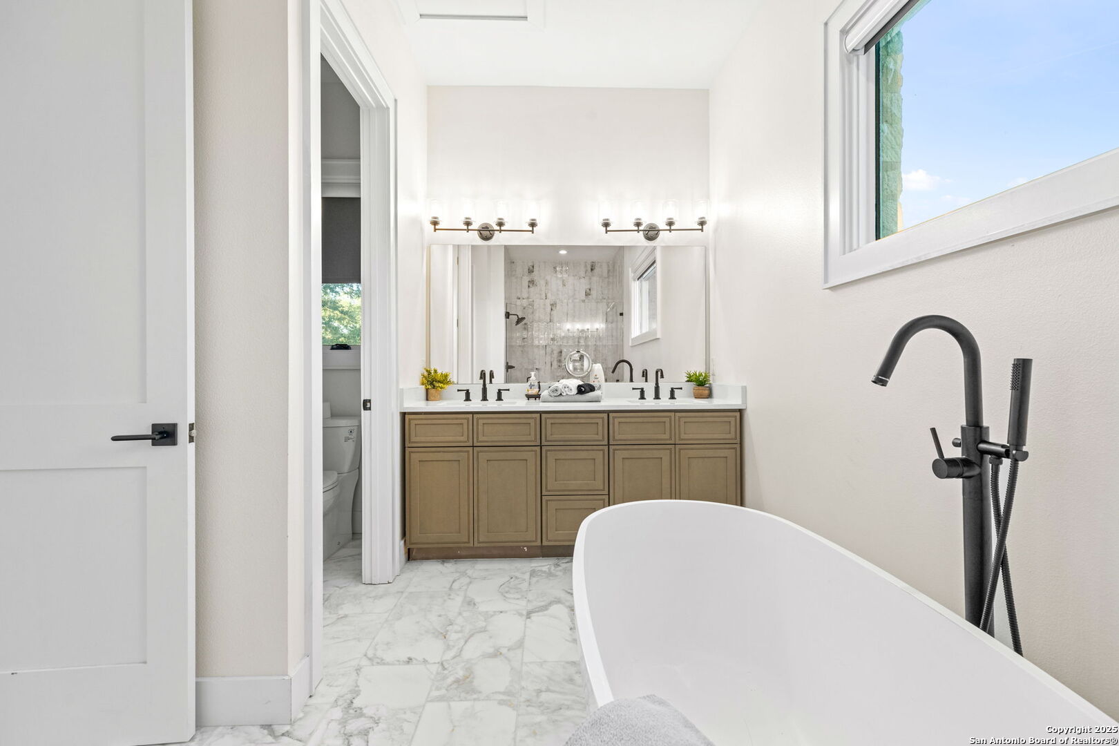 1146 Sisterdale Road Boerne, TX 78006 - Photo 40 of 94 a bathroom with a sink a mirror and vanity