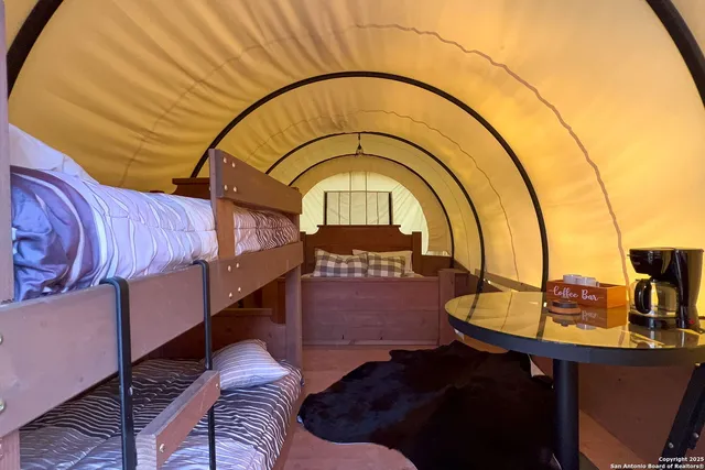a view of swimming pool with lawn chairs and large trees