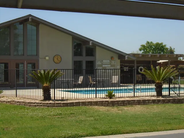 a view of a house with a fence in a yard