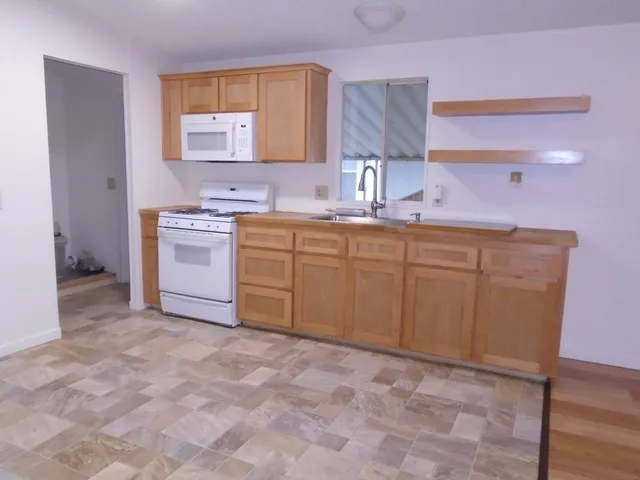 a kitchen with stainless steel appliances a sink stove and cabinets