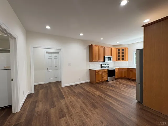 a kitchen with stainless steel appliances granite countertop a refrigerator and a sink