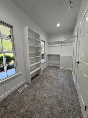 a view of a room with wooden floor and window