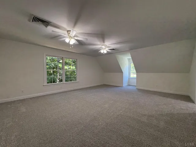 a view of an empty room with windows