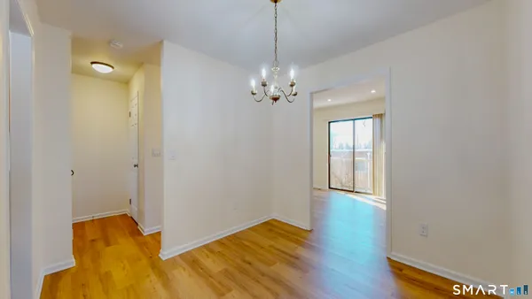 a view of a room with wooden floor and cabinet
