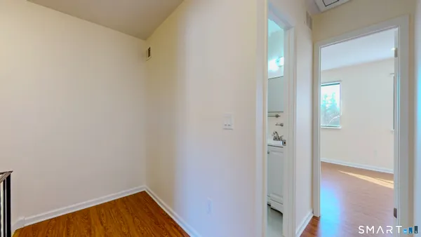 a view of a hallway with wooden floor
