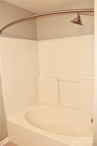 a bathroom with a shower and a mirror