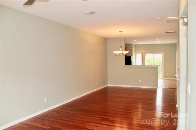 a view of a kitchen with wooden floor