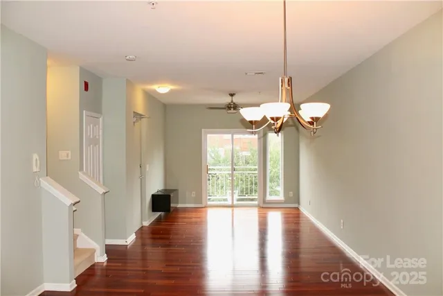 a view of a room with wooden floor and large windows