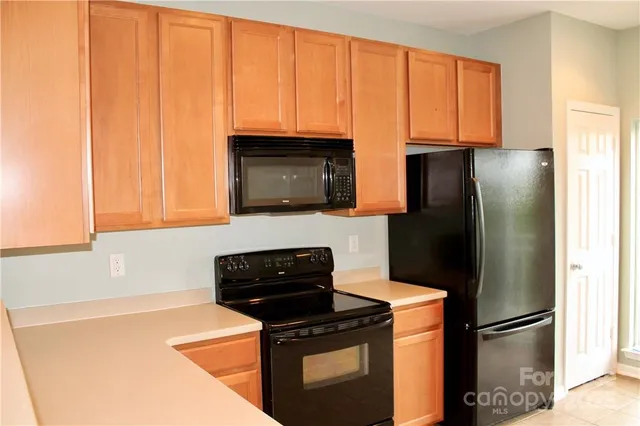 a kitchen with a refrigerator stove and microwave
