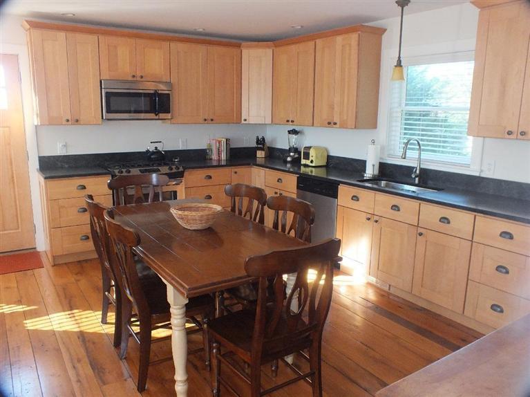 116 Castle Road Truro, MA 02666 - Photo 11 of 27 a kitchen with stainless steel appliances granite countertop a stove a sink a microwave and a refrigerator