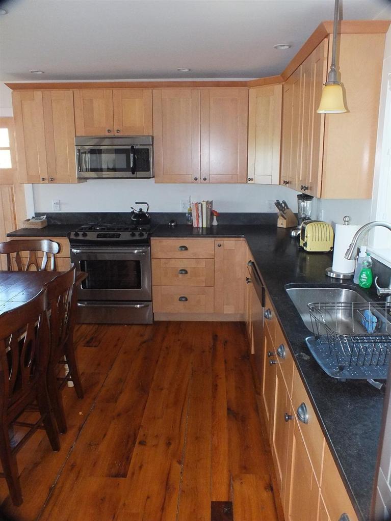 116 Castle Road Truro, MA 02666 - Photo 12 of 27 a kitchen with stainless steel appliances granite countertop wooden cabinets a stove top oven a sink and dishwasher