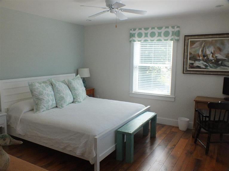 116 Castle Road Truro, MA 02666 - Photo 14 of 27 a bedroom with a bed and a table in it