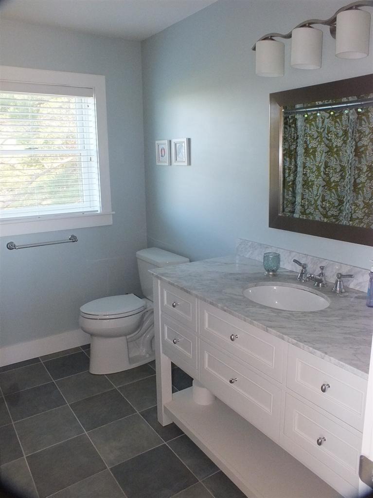 116 Castle Road Truro, MA 02666 - Photo 19 of 27 a bathroom with a granite countertop sink a toilet and a window