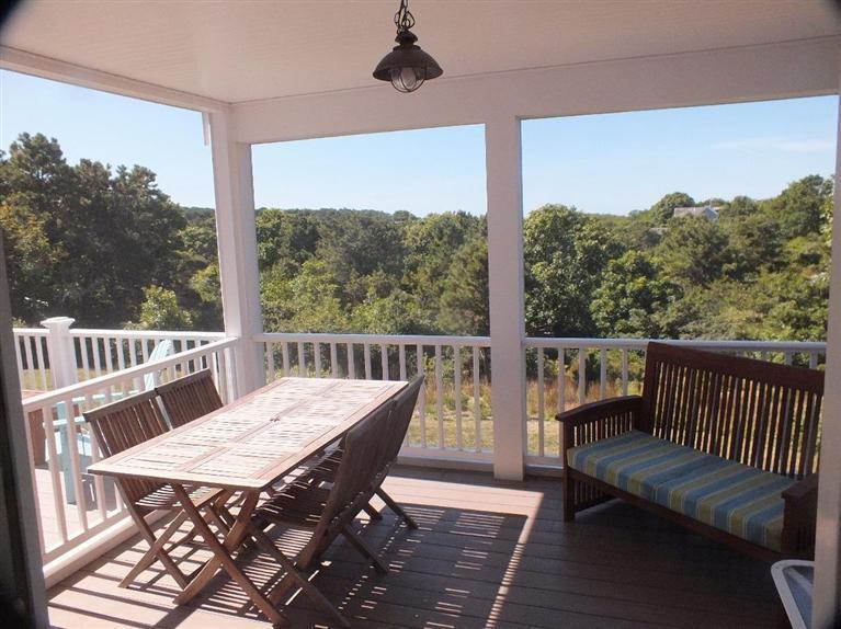 116 Castle Road Truro, MA 02666 - Photo 3 of 27 a view of a balcony with wooden floor and outdoor seating