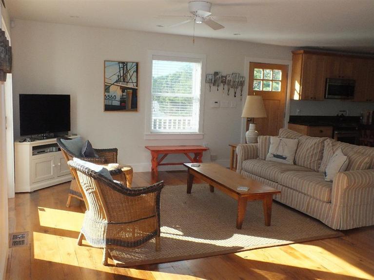 116 Castle Road Truro, MA 02666 - Photo 8 of 27 a living room with furniture a flat screen tv and a window