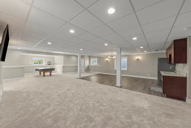 a view of a hall with kitchen and windows