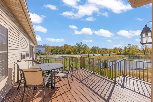 a view of a balcony with wooden floor and outdoor seating