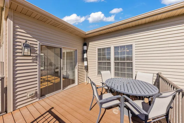a view of a patio with a table and chairs