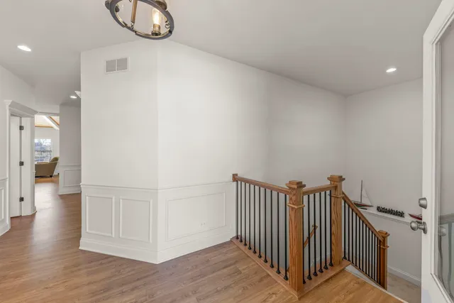 a view of a hallway view with wooden floor and staircase